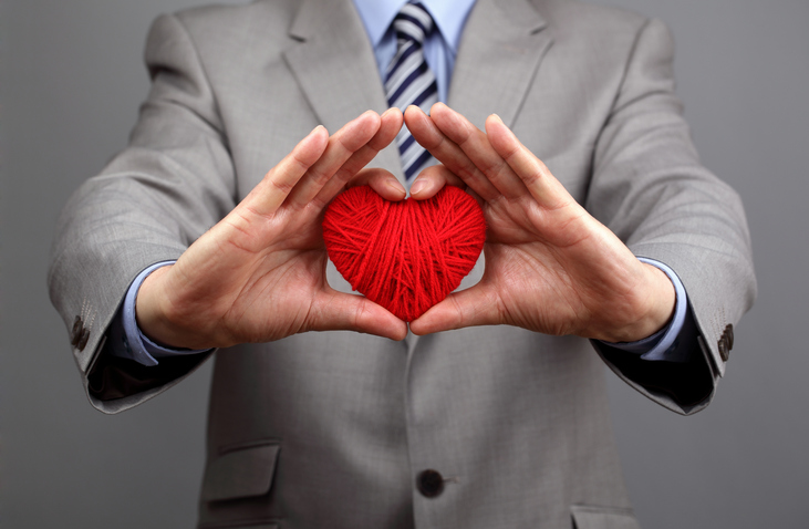 Man holding a red heart concept online dating business.